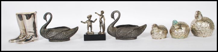 A collection of silver and white metal items to in