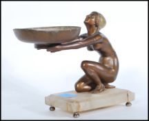 A 1930's Art Deco bronze and marble statue. The bronze kneeling lady with flapper hat holding out