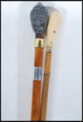 Two walking stick canes, one having knob handle in the form of King Edward VII and Queen Alexandra