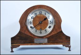 A early 20th Century Art Deco Napoleon hat oak case mantel clock having silverd dial with Arabic