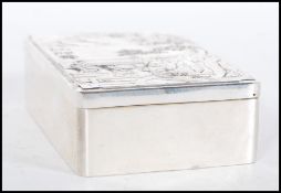 A silver white metal Chinese trinket box, the lid having relief oriental scene decoration