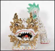 A large 20th Century ceramic Chinese Temple Fu dog figure having applied green raised decoration