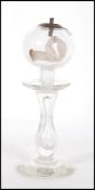 A 19th Century hand blown glass lacemakers oil lantern / lamp having a waisted stem with bulbous