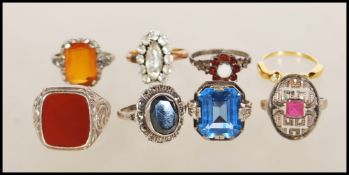 A collection of silver rings to include an art deco style having geometric pierced decoration set