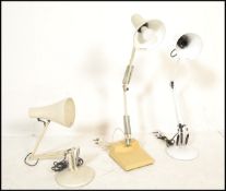 A group of three vintage 20th Century angle poise desk top lamps, all having a white enamelled