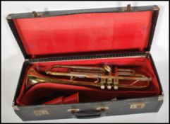 A vintage 20th Century cased Boosey & Hawkes Regent Trumpet, with mouthpiece & accessories within