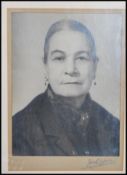 A 20th Century framed and glazed photograph of Anne Redpath OBE ARA ( Scottish artist ) being signed