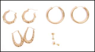 Four pairs of 9ct gold earrings. The earrings to include a large pair of hoops having etched