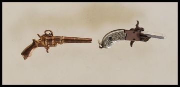 A 19th Century German miniature firing cap gun / pistol having engraved hilt and articulated