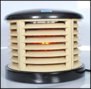 A post war Art Deco  century HMV 'Cavendish' demi-lune electric fan heater having bakelite top and