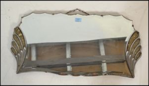 A vintage Art Deco 1920's frameless bevelled glass mirror having a symmetrical fanned design to