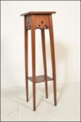 A Victorian 19th century Arts & Crafts oak plant stand torchere raised on squared legs with lower