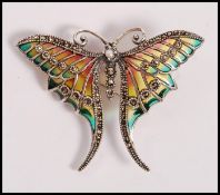A stamped 925 silver plique a jour brooch in the form of a butterfly set with marcasites. Weight