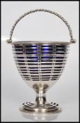A early 19th Century Regency silver hallmarked bonbon baskets having swing turned handle atop with