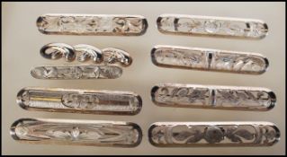 A selection of stamped 835 silver bar brooches having differing pierced floral decoration.