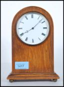 An Edwardian mahogany dome top mantel clock with enamel dial having roman numeral chapter ring and