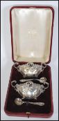 A pair of 19th Century Victorian silver hallmarked cased rococo style table salts and spoons,