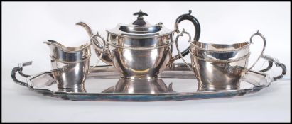 A silver plated tray of rectangular form with a scrolled moulded rim and twin carrying handles,