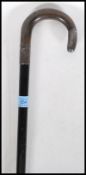 A silver hallmarked walking stick with ebonised shaft and a crook horn handle. Silver collar