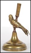 A late 19th / early 20th Century brass incense burner molded as a bird perching on a stand, having