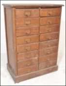 A 20th Century Industrial pine multi drawer tool chest / filing cabinet consisting of sixteen