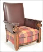 A 1930's Art Deco oak club type armchair raised on square carved supports with bulbous ball arm
