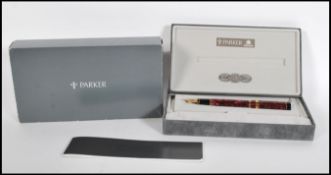 A boxed Parker, Duofold Centennial, maroon marbled fountain pen, the cap with gilt arrow clip and