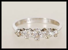 An 18ct white gold and diamond 5 stone ring. The ring being set with 5 graduated old cut