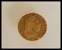 A George III 1798 gold spade guinea, with the head facing right and a crowned shield of arms. Weight