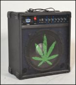A Custom Sound guitar amplifier model no. CS100B in black, with a leaf painted to the front.