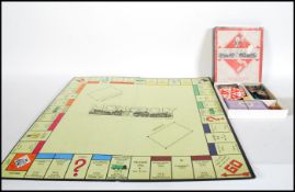A vintage early 20th Century wartime Monopoly set in good condition, the playing pieces made from