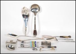 A collection of 20th Century kitchenalia to include a stamped 800 silver ladle with floral garland