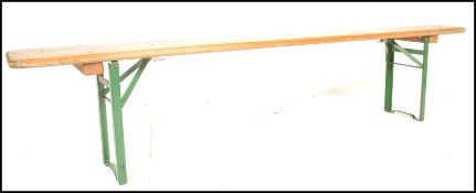 A mid 20th Century Industrial factory work bench. Of panelled wood with folding metal legs being