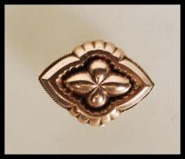 A 19th Century Victorian 9ct gold mourning brooch of quatrefoil form having a glazed panel to the