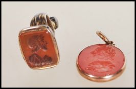An early / mid 19th Century seal pendant having a red stone oval seal carved with a seated maiden