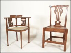 An Edwardian mahogany inlaid corner chair being raised on square tapering legs with pad feet