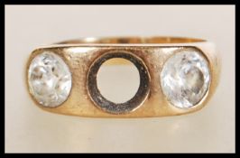 A stamped 18ct gold ring set with two round cut white stones (one missing). Weight 7.1g. Size T.