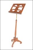 A late 19th Victorian / early 20th Century mahogany music / lectern stand, the adjustable central
