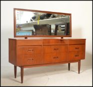 A vintage mid 20th Century teak wood Danish influenced dressing table, having a configuration of six