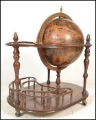 An antique style floor standing cocktail drinks cabinet in the form of a terrestrial globe with