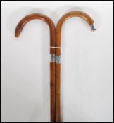 Two early 20th Century silver collared walking stick canes having crook handles. One made from