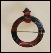 A late Victorian / early 20th Century Scottish agate and silver circle belt brooch having eight