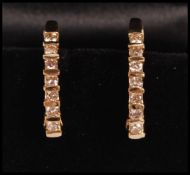 A pair of 14ct gold hoop earrings channel set with round diamonds. Weight 5.7g. Diamonds estimated