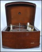 A 1950's mid century walnut cased Pye Black Box record player. The hinged top opening to reveal