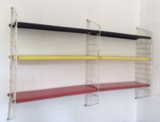 A retro 20th Century wall hanging metamorphic whatnot shelving system, constructed from metal