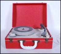 A vintage 20th Century circa 1960's portable record player in the form of a suitcase, lift up top