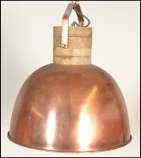 A vintage 20th Century industrial copper pendant ceiling light of domed form, having a black and