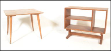 A mid 20th Century retro teak wood open book case raised on splayed legs having compartmentalised