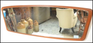 A vintage mid 20th century retro teak wood frameless atomic / sputnik style wall mirror of oblong