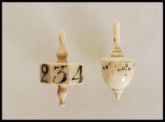 Two Georgian carved bone gaming dice / die spinning tops to include an octagonal spinner with